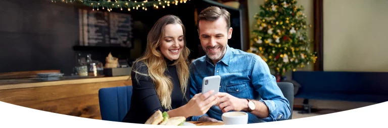 Couple looking at mobile device for local gifting with Gift Card Market