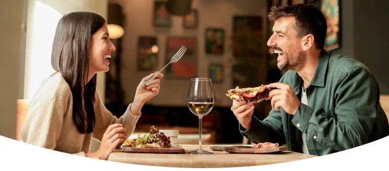 Couple eating dinner using a Gift Card Market restaurant gift card